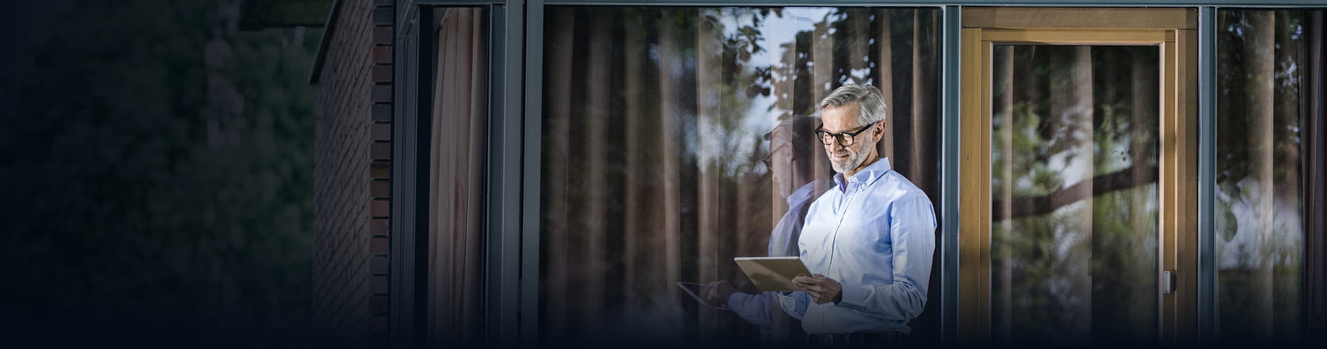 Professional using a tablet outdoors, representing StoneX Wealth Management's platform tools and resources for navigating today's market